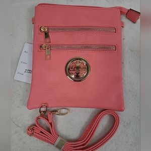Small pink Faux Leather  crossbody bag with gold accents. Brand new